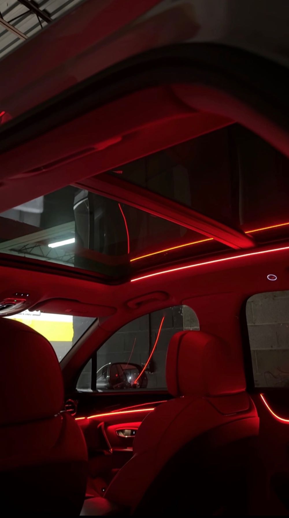 Red ambient light lines along the headliner and doors of an SUV