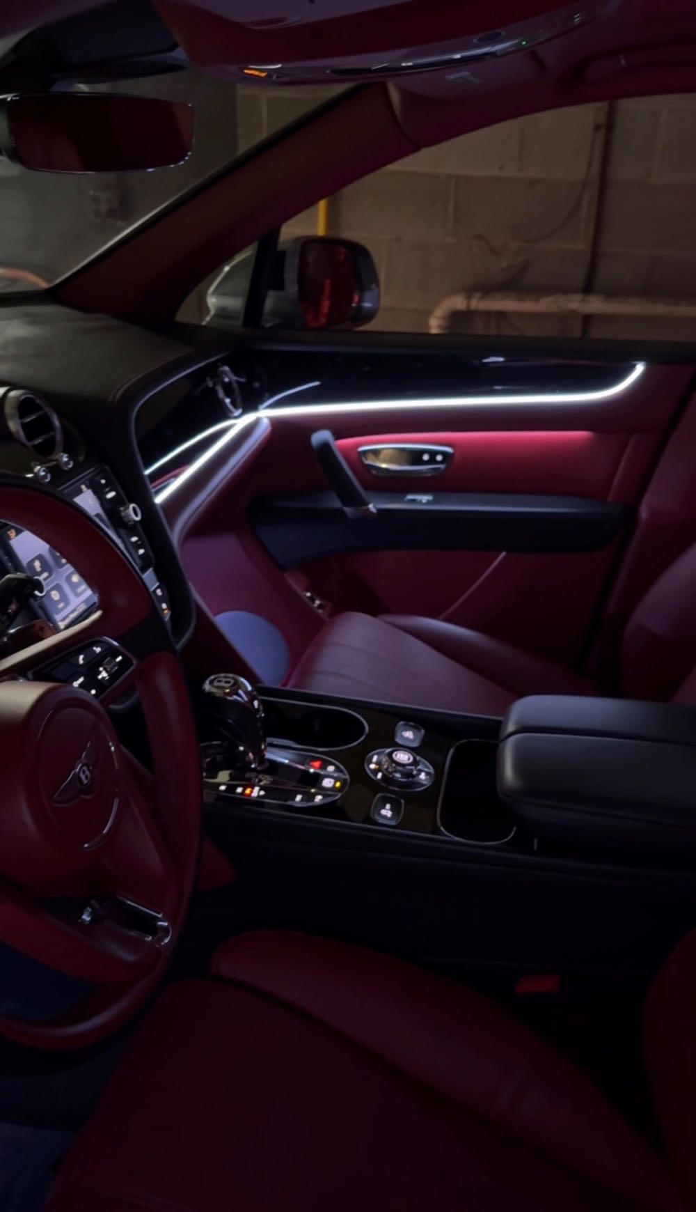 White ambient light strip across the red leather door of a Bentley Bentayga