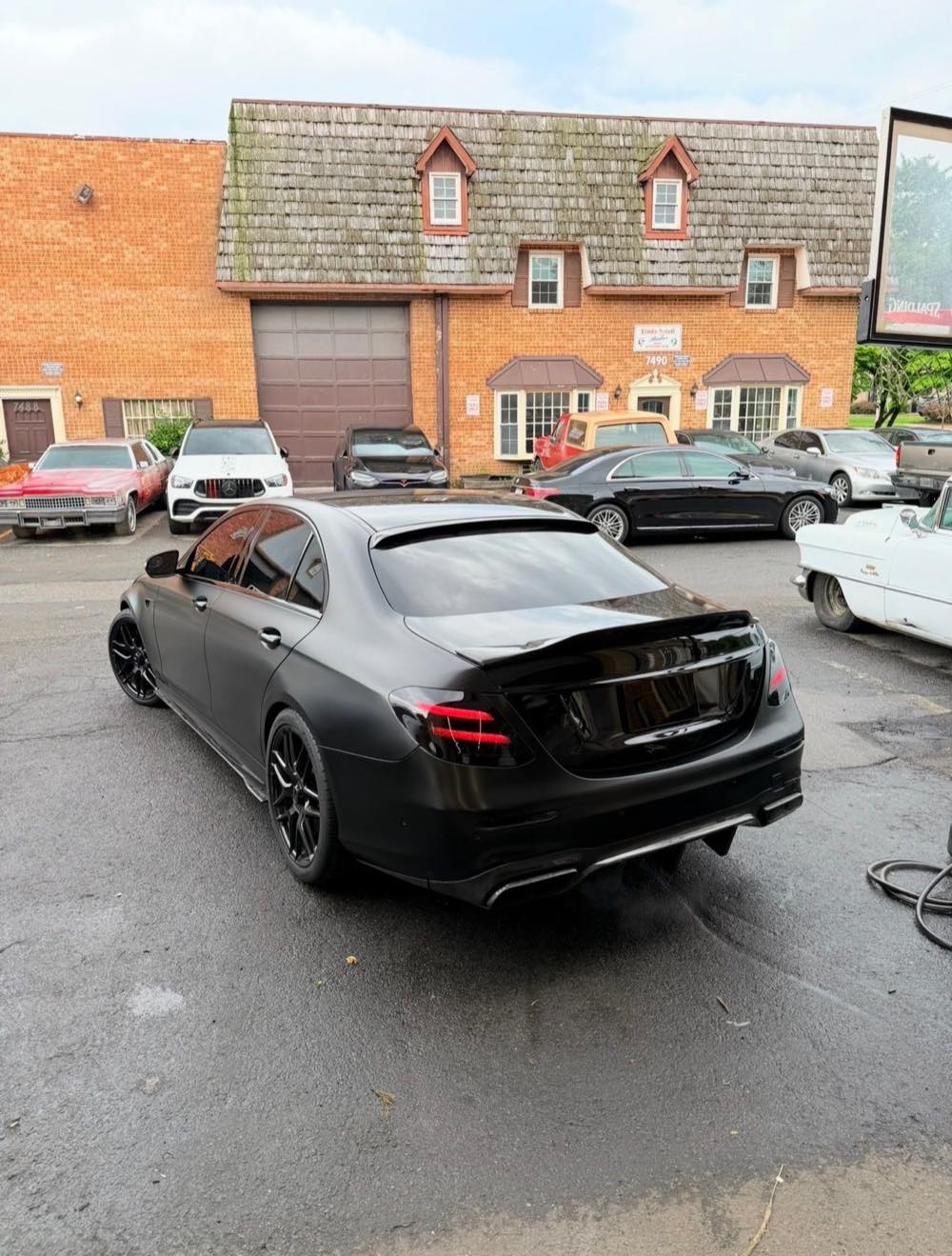 Rear view of a satin black wrapped Mercedes-AMG E63