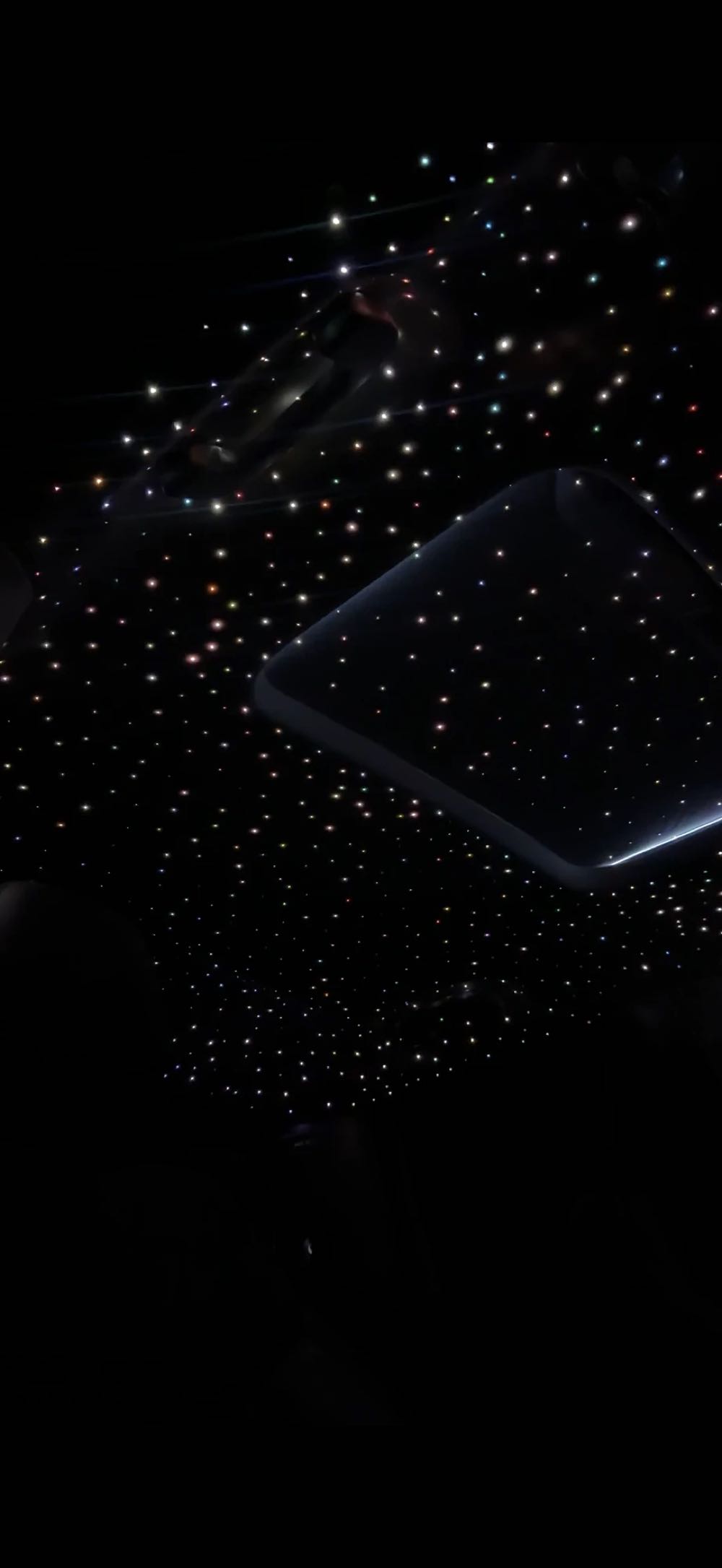 Hundreds of fiber-optic stars across a car headliner